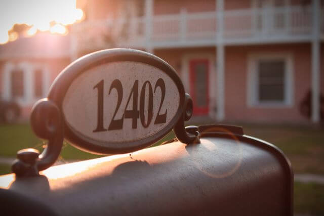Close view of a mailbox focusing on the address number, blurry house in the background